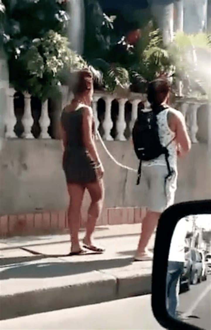 Tourist spotted walking his female companion along street on a dog lead in Colombia