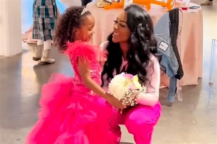 Kenya Moore's Daughter Brooklyn Melts Hearts as She Models Her New Louis Vuitton Purse in Denim Dress