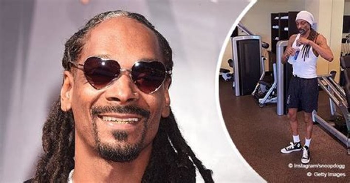 Snoop Dogg Shows off His Muscles Posing in a Gym Wearing a White T-Shirt & Sneakers