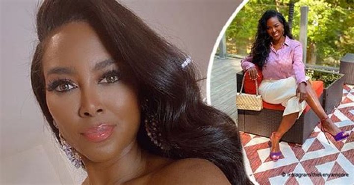 Kenya Moore Stuns in Pink Gucci Blouse and Shows off Her Chanel Handbag in a Photo
