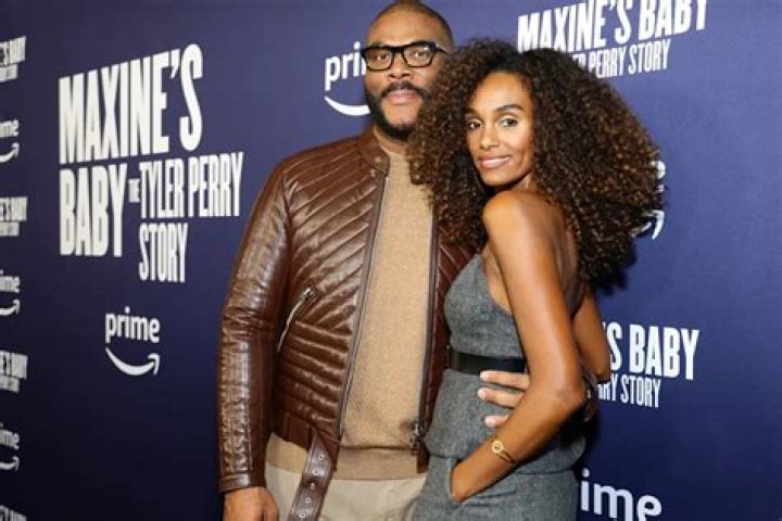 Tyler Perry's Girlfriend Gelila Shows Curls & Fit Legs in Skirt with Tights & a Fluffy Jacket