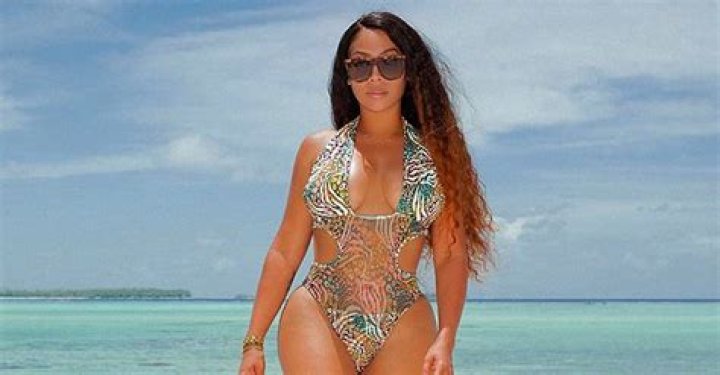 La La Anthony Enjoys Vacation Posing for Stunning Pic in Cool Swimsuit with a Deep Neckline
