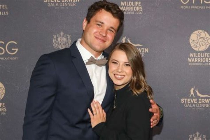 Bindi Irwin & Her Husband Chandler Powell Cradle Her Growing Baby Bump in a Sweet Photo