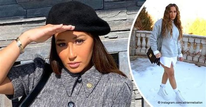Adrienne Bailon Braves the Snow as She Exposes Toned Legs in a White T-Shirt Dress & Sweater