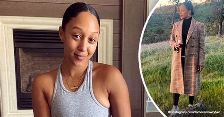Tamera Mowry Enjoys a Glass of Wine in Stunning IG Post Posing in a Long Checkered Coat