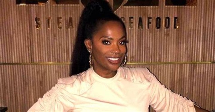 RHOA Star Kandi Burruss Puts Her Legs on Display in Black Polka Dot Stockings & Plunging Jacket