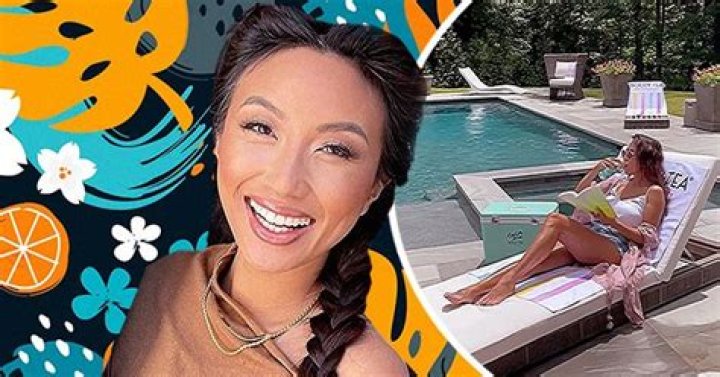 Jeannie Mai Flaunts Long & Slender Legs While Lounging by the Pool in Skimpy Shorts & White Top