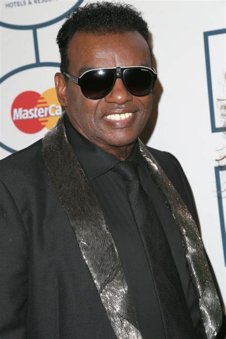 Ron Isley Defies His 80 Years Posing in Versace & Carefully Holding Hands with Much Younger 2nd Wife