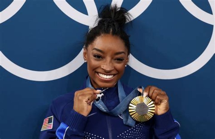 Simone Biles flaunts her toned abs and legs in sports bra and tiny shorts